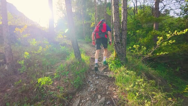 Walking on eroded rock on the path to Chorros de Fornos, Badain, Ainsa, Aragonese Pyrenees, spectacular natural scenery with warm afternoon light filmed in 4K
