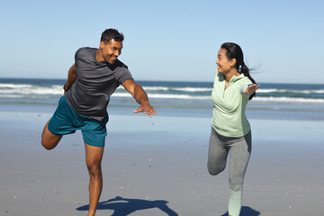Fototapeta premium Couple enjoying playful run on beach, smiling and embracing moment