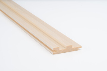 Light-colored wooden molding profile with clean grooves, shown on white background. Cross-sectional view highlights detailed woodworking..