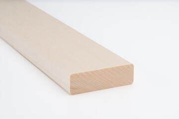 Smooth, light-colored wooden board with rounded edge shown on white background. Close-up of solid wood piece, ideal for carpentry or furniture..