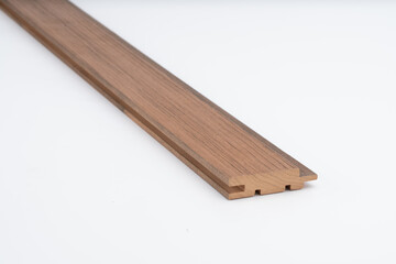 Brown wood panel with precision-cut grooves and straight edges, displayed on a white background. Ideal for wall systems, flooring, or cabinetry work..