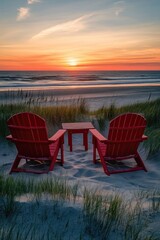 Fototapeta premium Two red beach chairs on the sand at sunset