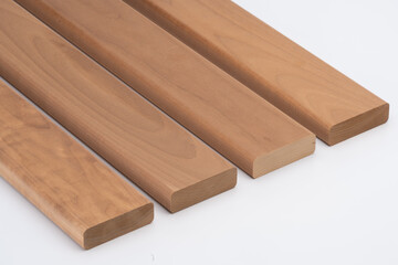 Four solid wood slats with rounded edges laid side by side on a white background, showcasing natural grain and smooth surface. Ideal for product mockups..
