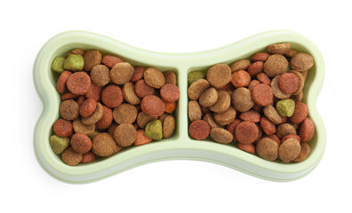 Dry pet food in feeding bowl isolated on white, top view