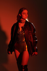 Elegant young woman dressed in knightcore fashion exudes confidence in a warm, atmospheric setting