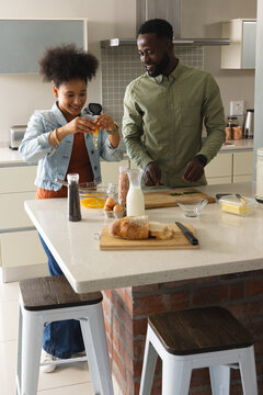 Cooking together, couple preparing breakfast with fresh ingredients in modern kitchen