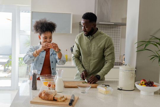 Couple preparing meal together in modern kitchen, enjoying quality time cooking