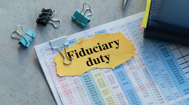 Fiduciary duty text on yellow paper on a gray background
