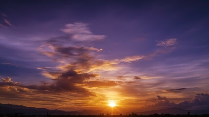 Fototapeta premium Golden sunset over a serene landscape, warm light through clouds, orange and purple hues blending in harmony