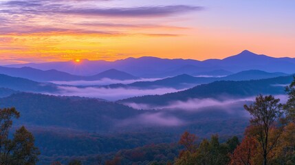 Obraz premium Golden sunset over a serene landscape, warm light through clouds, orange and purple hues blending in harmony