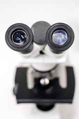 Scientific microscope during research, analyzing data in the lab, research for vaccine production. Concept of biological sciences, viruses and treatment.