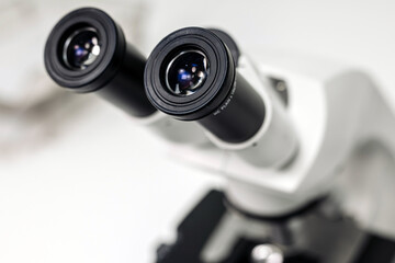 A biologist or virologist conducts diagnostic studies by working with a close-up microscope....