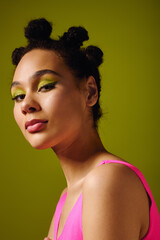 Young beautiful woman showcasing modern fashion with vibrant colors in a creative setting