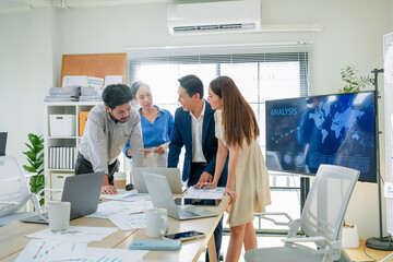 Focused business strategists stand head-to-head in a modern office, concentrating on agile planning...