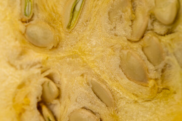 Slice yellow zucchini, slicing ripe zucchini on a black cooking table
