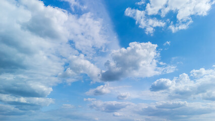 Vast blue sky with scattered white clouds creates a tranquil atmosphere, perfect for illustrating themes of nature, serenity, or peacefulness in various contexts.