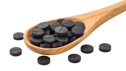 activated carbon pills on a spoon, isolated png transparent background