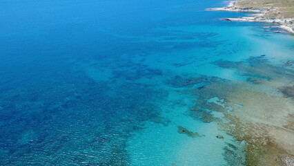  Aerial View of a Tranquil Turquoise Coastline with Rocky Cliffs and Sandy Beach