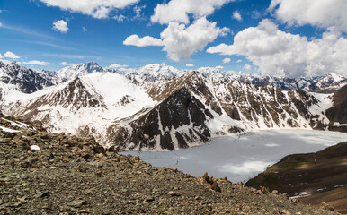 Aerial panoramic view over the frozen  lake Ala-Kul from mountain pass. Tien Shan. Kyrgyzstan