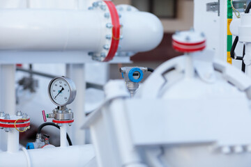 industrial pipeline with analog and digital gauges