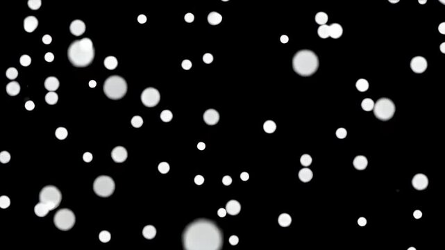 A seamless loop animation of soft white snow dots or chunks gently falling against a pitch-black background.