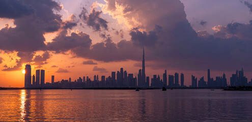 panoramic sunset view of Dubai Downtown cityline from Dubai Creek harbour