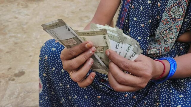 Indian female counting 500 rupees Indian currency notes