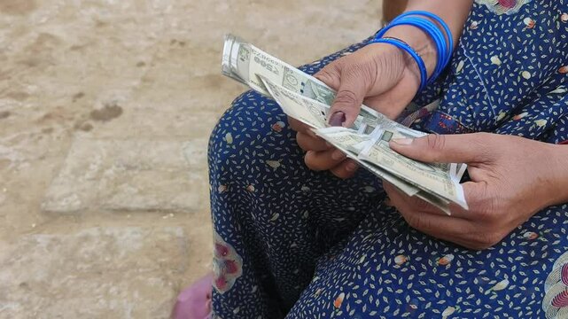 Indian female counting 500 rupees Indian currency notes
