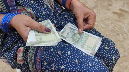 Indian female counting 500 rupees Indian currency notes