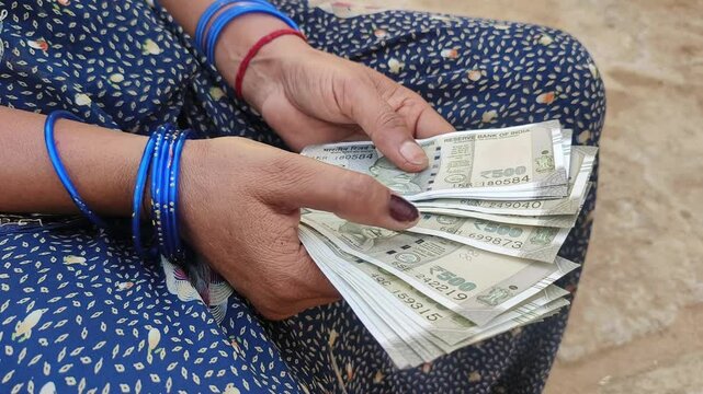 Indian female counting 500 rupees Indian currency notes