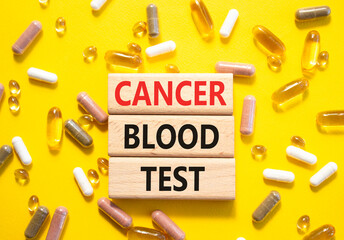 Cancer Blood Test symbol. Concept word Cancer Blood Test on wooden blocks. Beautiful yellow...