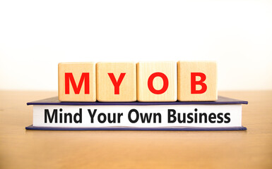 MYOB mind your own business symbol. Concept word MYOB Mind Your Own Business on beautiful wooden...