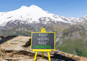 Keep going and growing symbol. Concept words phrase Keep going keep growing on beautiful black...