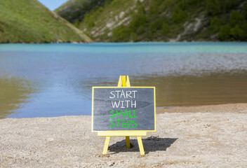 Start with small steps symbol. Concept words phrase Start with small steps on beautiful black...