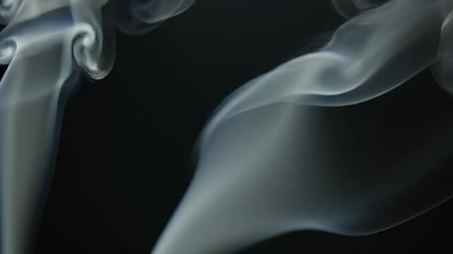 A high-resolution cinematic animation of white and grey smoke over a pure black background.