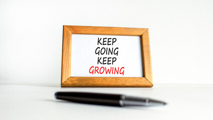 Keep going and growing symbol. Concept words phrase Keep going keep growing on beautiful wooden...