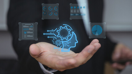 A businessman holding virtual screens with artificial intelligence and data analytics interface in...
