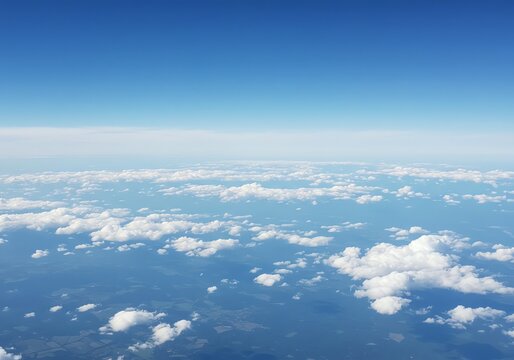 Aerial view showcases a sky filled with fluffy clouds and clear blue sky