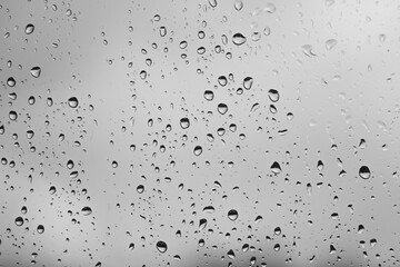 black and white moody raindrops on a window glass