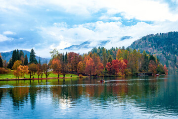 Autumn lake Bled, Julian Alps mountain, boats at distance in Slovenia