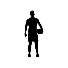 A football player is standing with a football in his hand silhouette .
