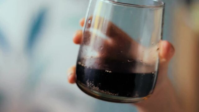 Child Drinking Cola from Transparent Glass Jar &ndash; Close-Up Slow Motion