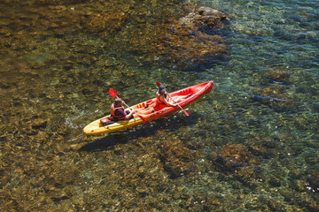 Dubrovnik, 28.06.2019, Croatia: Two people floating in a canoe. View from above