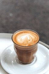 Cappuccino in a glass glass in a cafe
