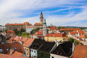 Fototapeta premium Panoramic view of the colorful roofs of Cesky Krumlov and a medieval castle towering over the town.Czech Republic 