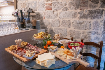 Traditional wooden board with assorted Italian cured meats and salami ready to serve