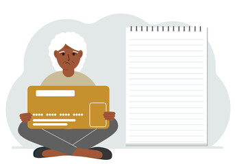A woman sits cross-legged in his hands holding a large credit card next to a close-up notepad for text. Concept of credit card, expense planning, income planning.
