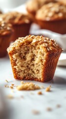 Scrumptious homemade muffin baked to perfection with a golden crust and topped with oat streusel, set on a marble countertop, inviting you to enjoy a delightful treat