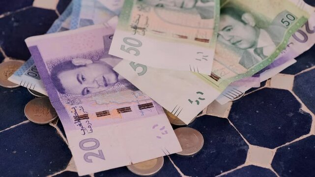 closeup Moroccan dirham money, coins on traditional table, count paper dirham banknotes, cash payments, monetary savings, save for vacation, exchange and cashing currency