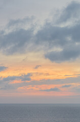 Fototapeta premium Beautiful sunrise over the ocean with birds soaring through the morning sky. The soft glow of dawn bathes the water and horizon in gentle pastel colors, creating a peaceful and atmospheric coastal sce